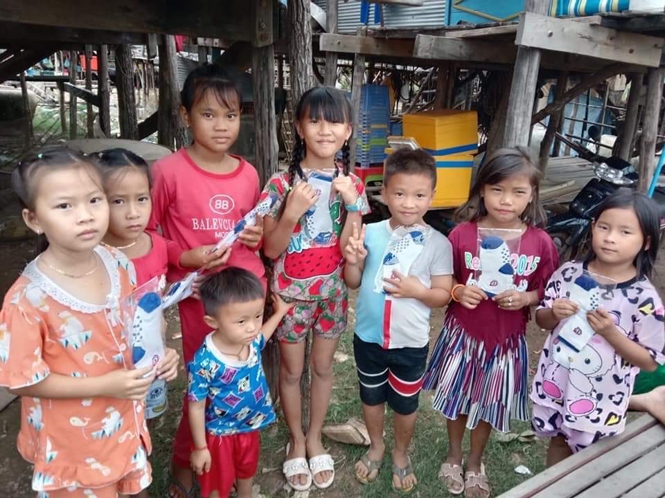 Children in their village in Kampong Chhnang holding gifted socks