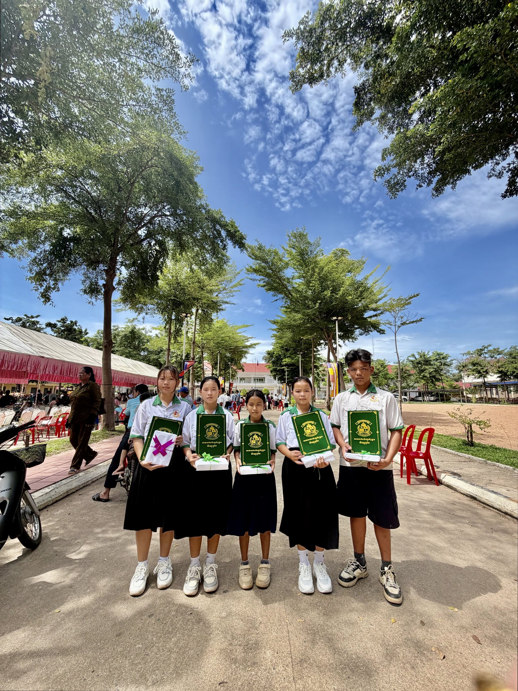 Five IHM students holding their academic honor certificates in Kampong Chhnang
