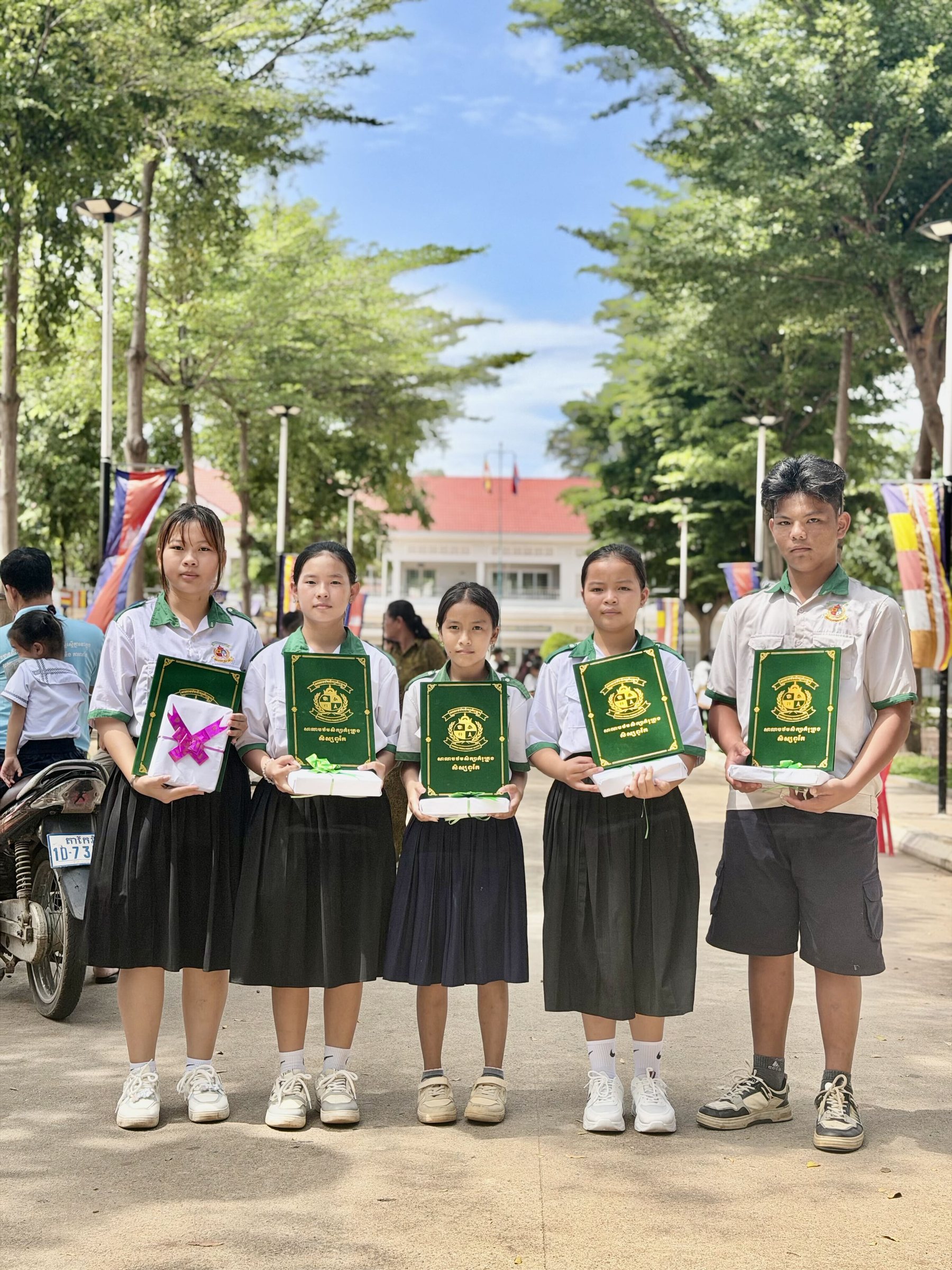 Five IHM students holding their academic honor certificates in Kampong Chhnang