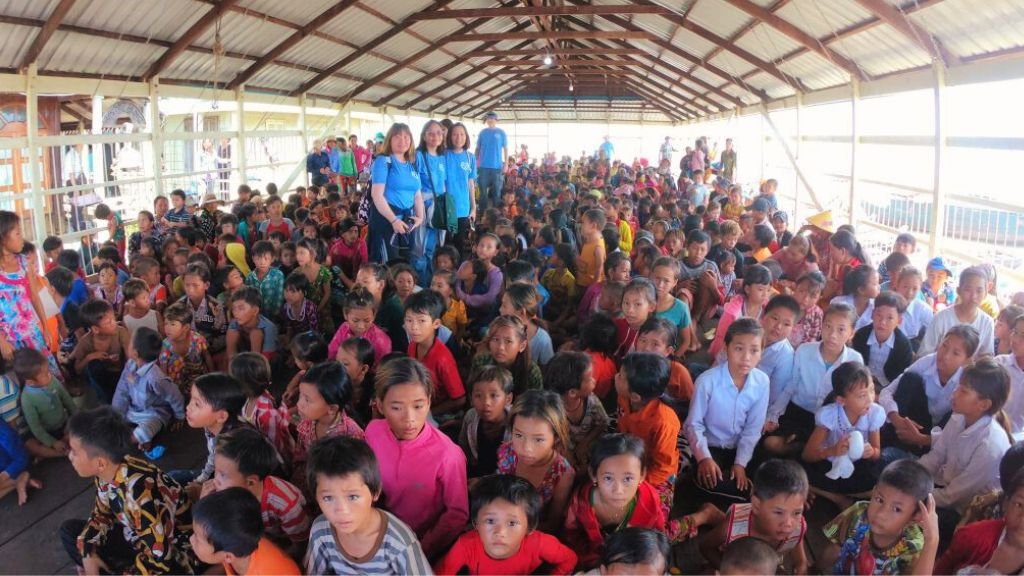 Hundreds of children gathered at a floating village with the IHM team in 2019