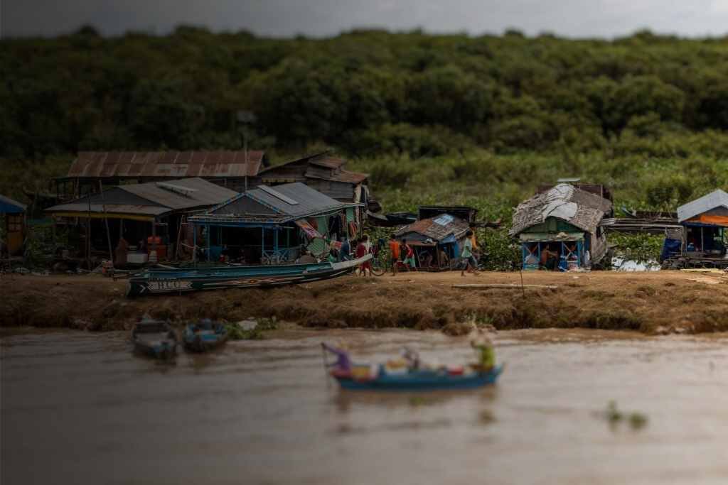 Floating wooden homes on the bank of the Tonle Sap River in Phnom Penh — the Reuters report that IHM curated