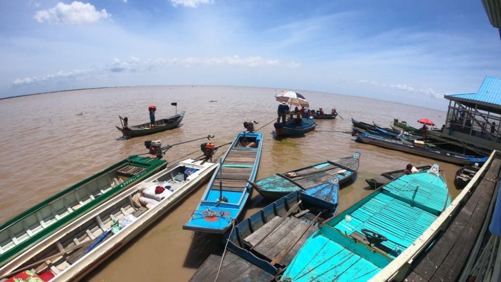 Boats moored at the floating village dock on Tonle Sap Lake — the families affected by the land relocation policy